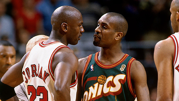 CHICAGO - JUNE 7:  Michael Jordan #23 of the Chicago Bulls exchanges words with Gary Payton #20 of the Seattle SuperSonics during Game Two of the 1996 NBA Finals at the United Center on June 7, 1996 in Chicago, Illinois. The Bulls won 92-88.  NOTE TO USER: User expressly acknowledges that, by downloading and or using this photograph, User is consenting to the terms and conditions of the Getty Images License agreement. Mandatory Copyright Notice: Copyright 1996 NBAE (Photo by Andrew Bernstein/NBAE via Getty Images)